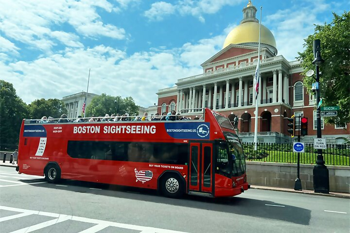 Boston Sightseeing Double Decker bus is in front of Massachusetts State House